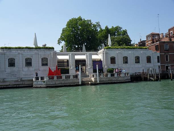 Venier of the Palace Lions Venice, Veneto, Italy - June 2, 2014: the start of construction dates back to 1748 by the architect Lorenzo Boschetti. At the end of 1948 it was acquired by Peggy Guggenheim, a passionate art collector who, in addition to contemplate them in their home, opened to the public the palace and its art collection. After his death in 1979, is the palace that the collection was donated to the Solomon R. Guggenheim Foundation after the municipality of Venice it refused the bequest. Today is one of the most important modern art museums in the world peggy guggenheim stock pictures, royalty-free photos & images