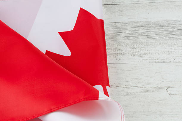 istock Canadian flag folded on white rustic wooden table 532871382