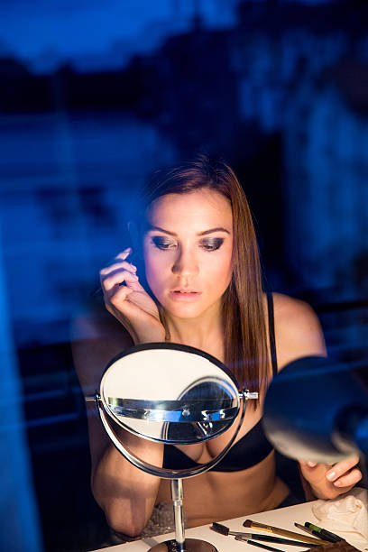 istock Young woman applying make-up 532871481