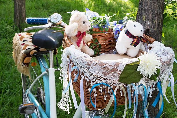 teddy bears lies in a retro bike basket