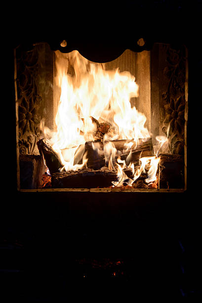 Flame in fireplace Flame in fireplace with burning wood in evening michael owen stock pictures, royalty-free photos & images
