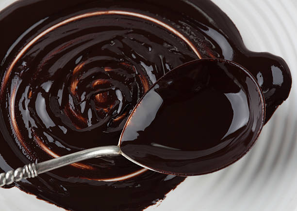 istock Big spoon covered in melted chocolate closeup 532871864
