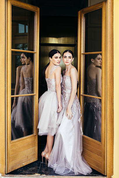 Two beautiful girls wearing dresses