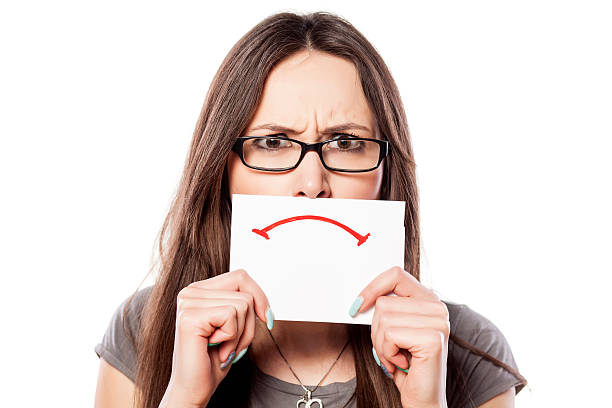 istock Angry girl with a sad smile drawn on paper 532872433