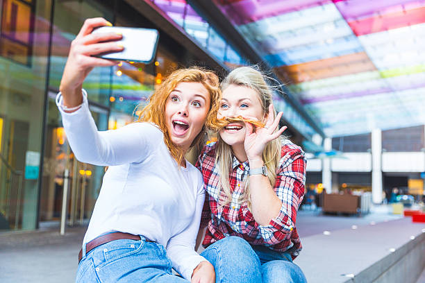 istock Two beautiful women taking a funny selfie 532874202