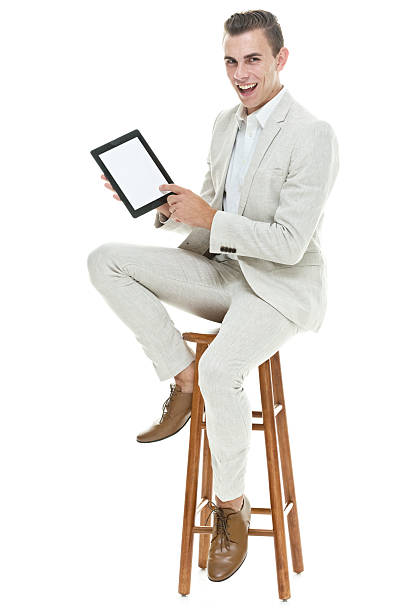 istock Smiling businessman holding tablet 532875522