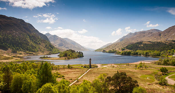 Glenfinnan Monument Loch Shiel nestled between mountains at Glenfinnan in the Highlands of Scotland, with the Glenfinnan Monument to Charles Edward Stuart and the Jacobite uprising on the shores of the lake. glenfinnan monument stock pictures, royalty-free photos & images