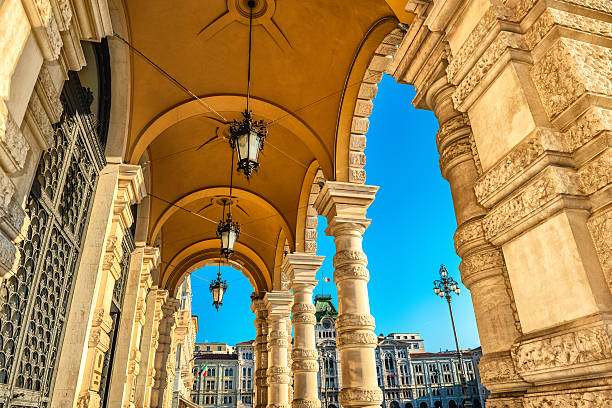 Fountain and The Town Hall in Piazza Unità d'Italia (Unity of Italy Square) at the main square of the northern Italian city of Trieste. Beautiful blue clear sky in the background.