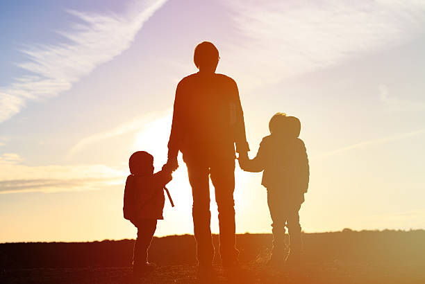 istock father and two kids travel at sunset 532877916