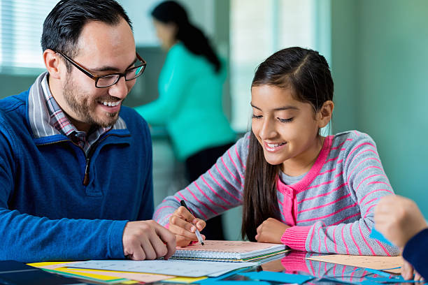 istock Confident schoolgirl works on homework 532879636