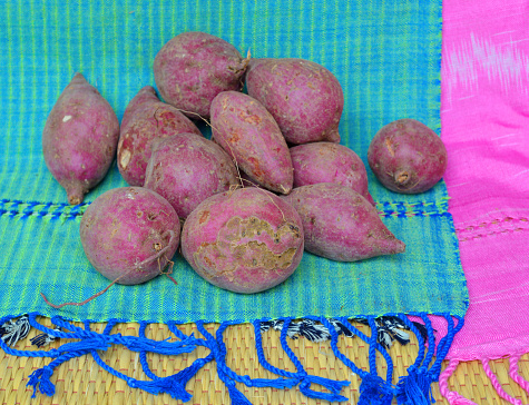 pile of sweet potatoes on handwoven cotton clothes