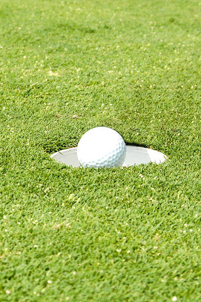istock Playing Golf - Putting the ball into the hole. 532912605