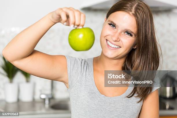 Cheerful Young Woman With An Apple Stock Photo - Download Image Now - 2015, Adult, Adults Only