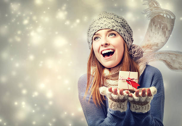 istock Happy young woman holding a small present box 532936739