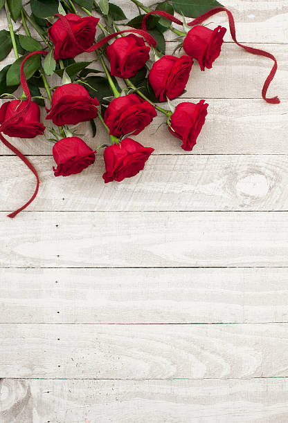 istock Valentine's day red roses bouquet on old rustic wood table 532936997
