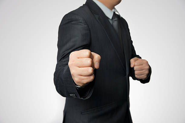 istock Man in gray suit ready to fight 532937301