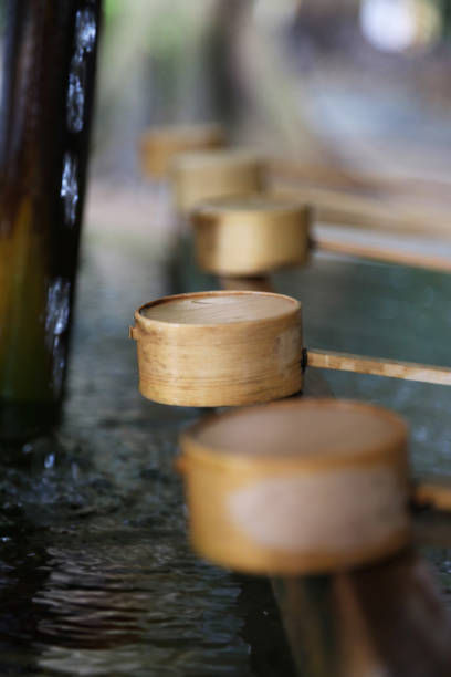 Tokyo, Japan - August 28, 2014: A purification trough by the entrance to the Meiji Shrine in Tokyo. Shinto observers use it to wash their hands and mouths before entering the shrine.