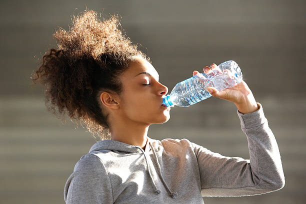 istock Attractive young woman drinking water from bottle 532939447