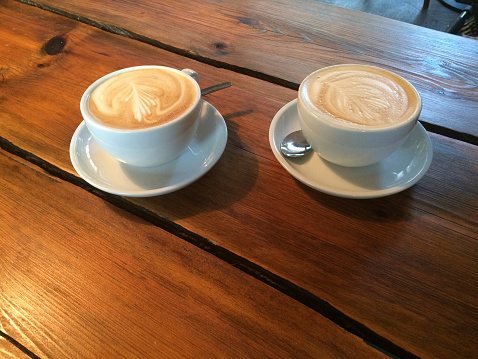 Two cups of coffee on wooden table