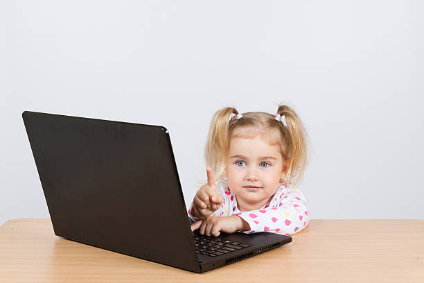 istock little girl at the computer. 532948592