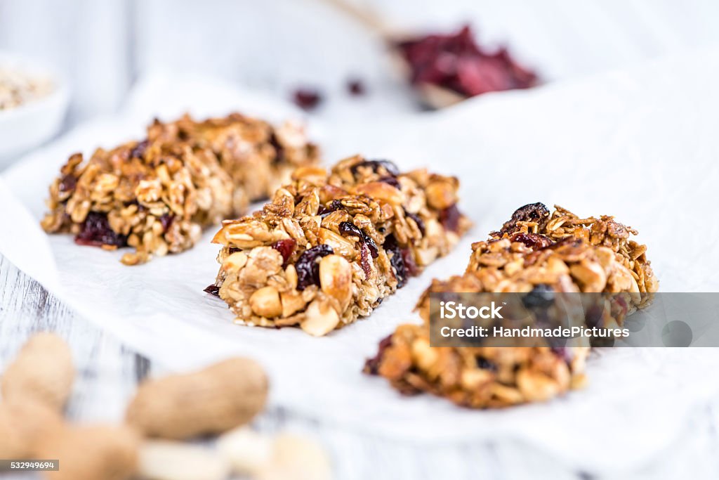 Homemade Granola Bars with Peanuts and Cranberries (selective fo Homemade Granola Bars with Peanuts and Cranberries (selective focus) as detailed close-up shot Protein Bar Stock Photo