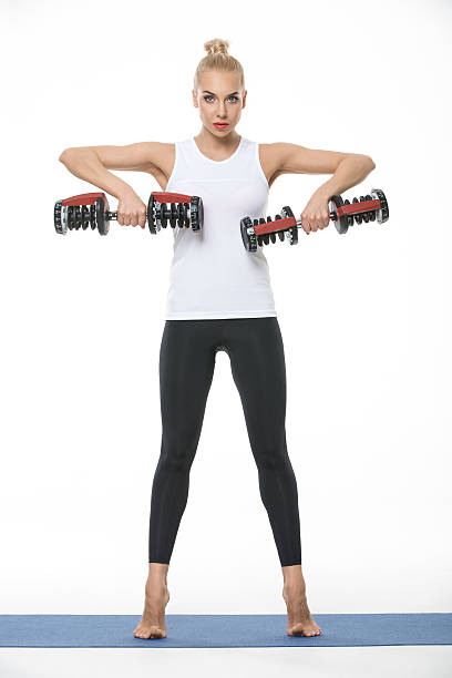 istock Sportive girl with dumbbells 532950050