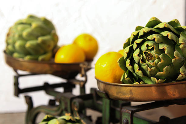 fresh artichokes on rustic wooden background  with lemon