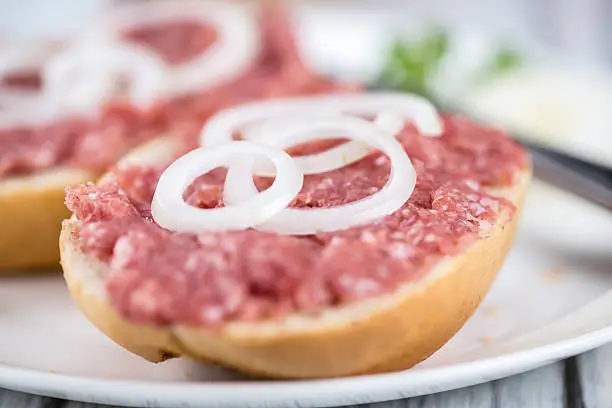Fresh made Bun with Mett (selective focus) on an old wooden table