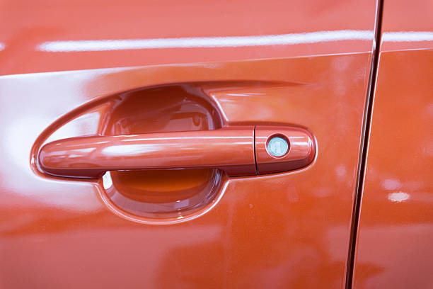 istock door handle of new orange car 532952520