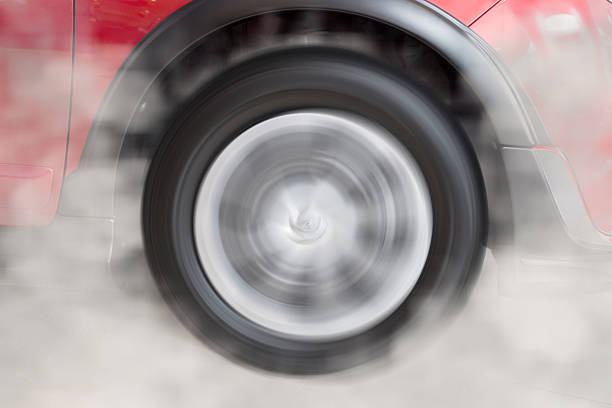 istock drifting and smoking wheel of new red car 532952618