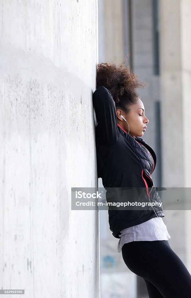 Young woman relaxing after workout Side view portrait of a young woman relaxing after workout 20-24 Years Stock Photo