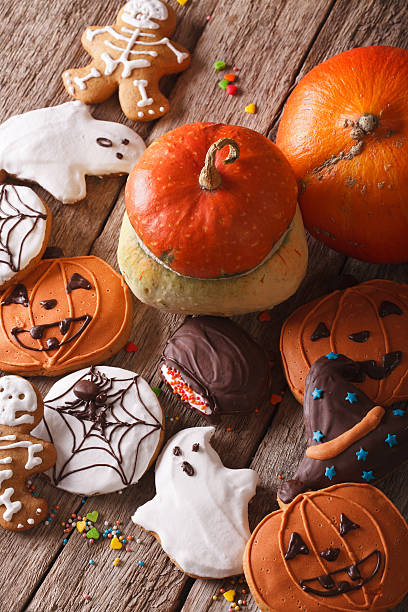 istock Funny Halloween gingerbread cookies and pumpkin. vertical top view 532954564