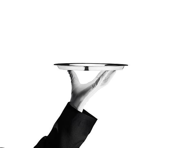 Waiter - Stock Image A waiter holding an empty silver platter.  formal glove stock pictures, royalty-free photos & images