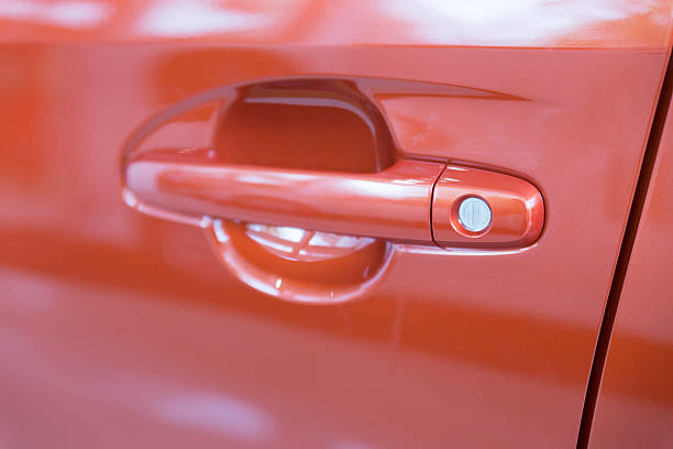 istock door handle of new orange car 532955812