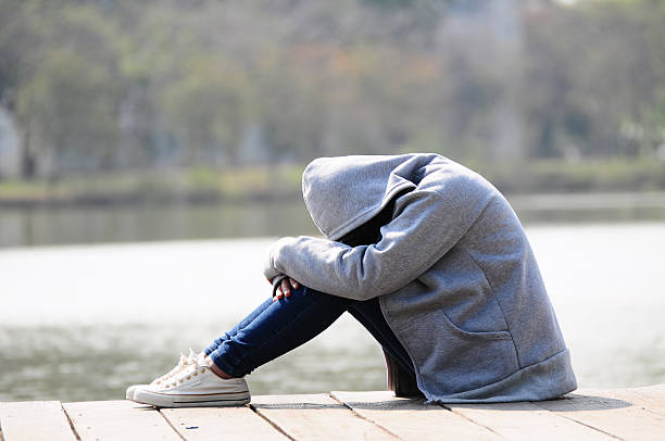 istock Close up sad woman sitting near river 532955902