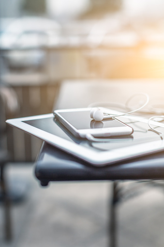 smartphone with headphones stacking on a tablet PC,still life.