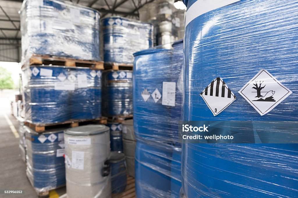 Environmental hazard barrels Waste barrels with hazard warning symbols in the warehouse Toxic Waste Stock Photo