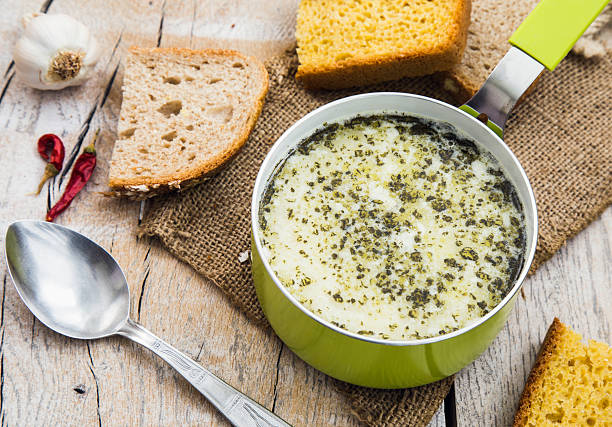Homemade Turkish yogurt soup, red peppers and bread Homemade Turkish yogurt soup, red peppers and bread on the wooden table plateau concept stock pictures, royalty-free photos & images