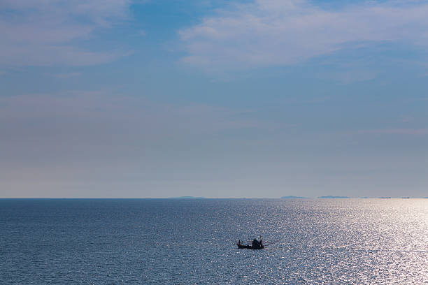 istock Small lonely boat in the big ocean, natural skyline 532958164