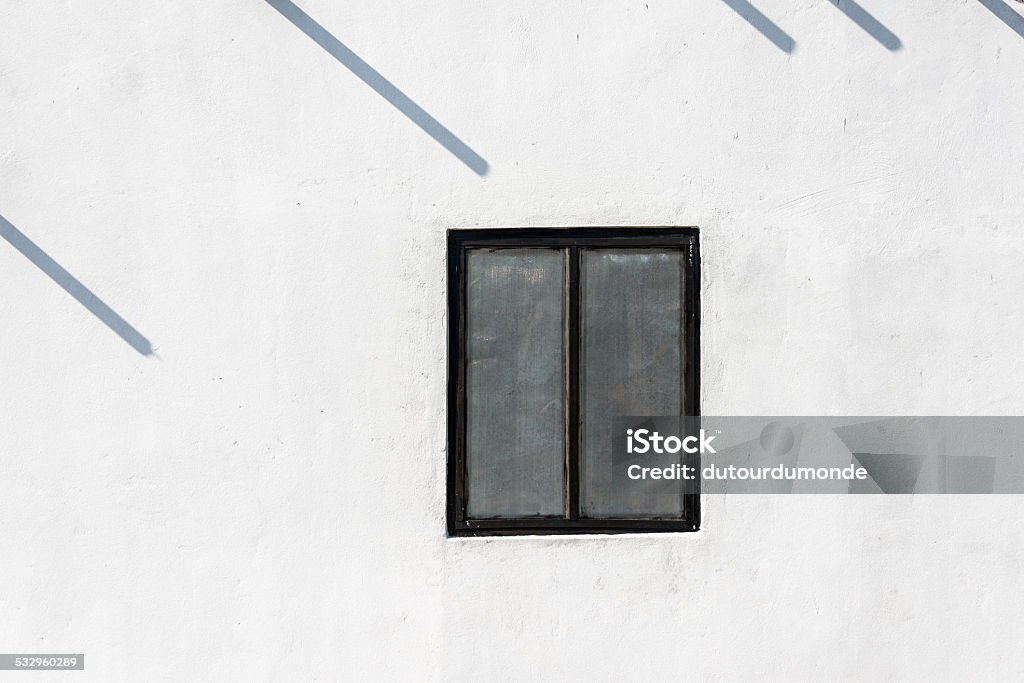 Window on white wall Window on white wall and poles shadow 2015 Stock Photo