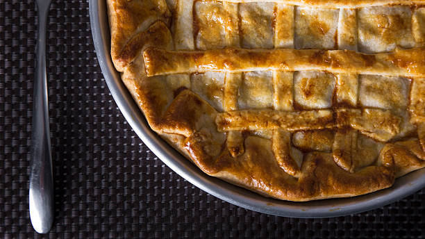 istock Meat striped pie on a black and aluminum tablecloth 532960476
