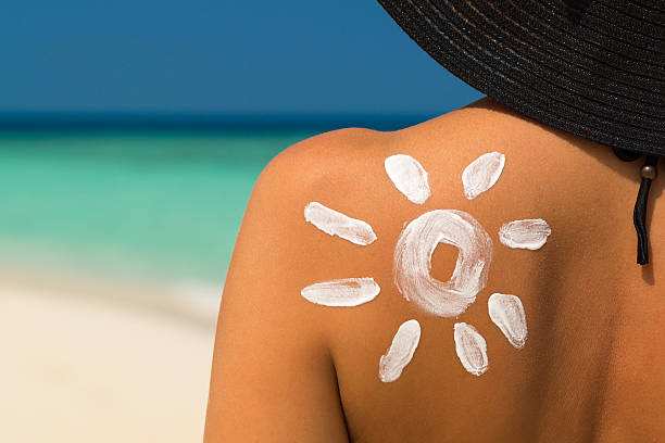 istock Woman with sun-shaped sun cream 532960836