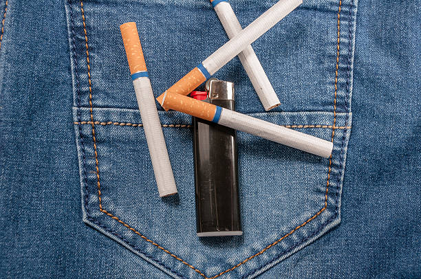 istock Pack of cigarettes and lighter in pocket jeans 532961142