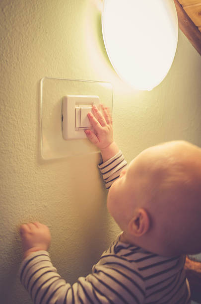 Baby child switching on / off the light