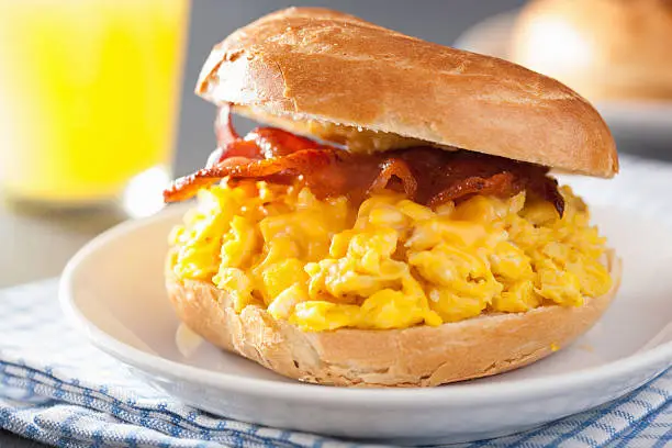 Photo of breakfast sandwich on bagel with egg bacon cheese