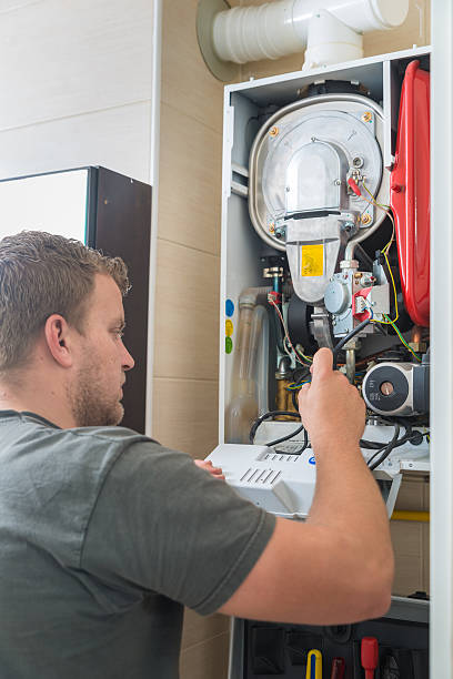 Technician repairing Gas Furnace stock photo