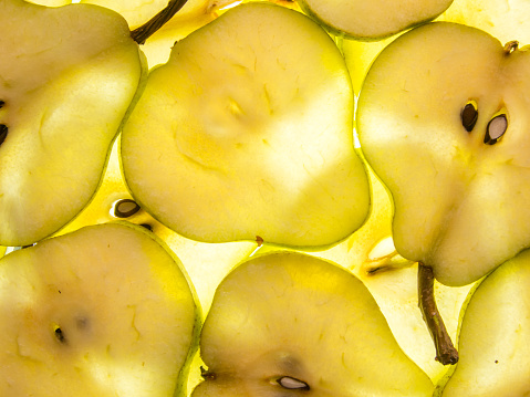 background of ripe back lit pear slices