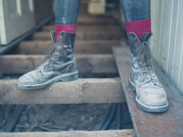 istock Feet of worker standing on floor joists 532972778