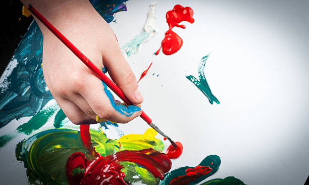 istock Child hand coloring on paper with acrylic 532976424