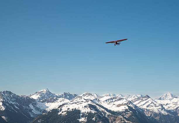 red plane flying over the alps